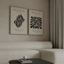 Set of 2 beige abstract posters styled in japandi bedroom with minimal decor
