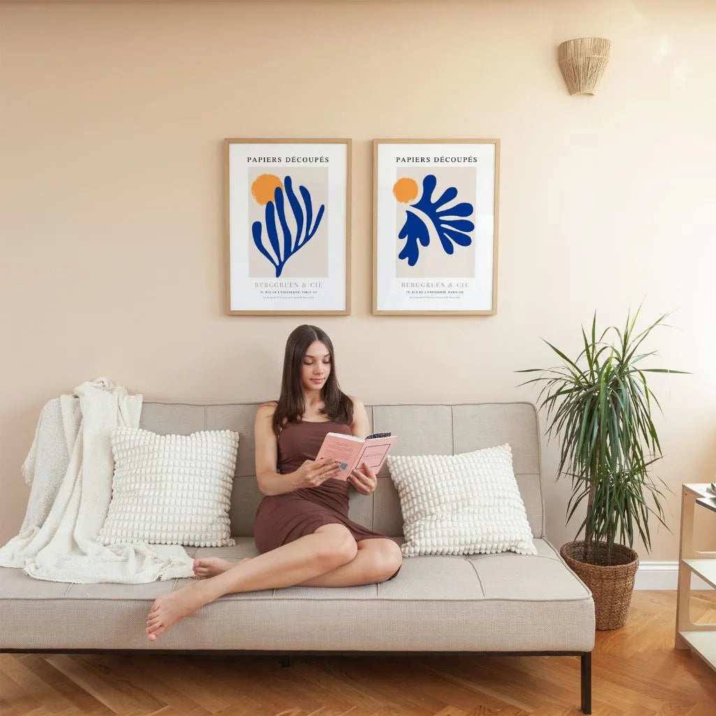 Close up of blue cutouts poster set showing deep blue organic shapes and orange contrast